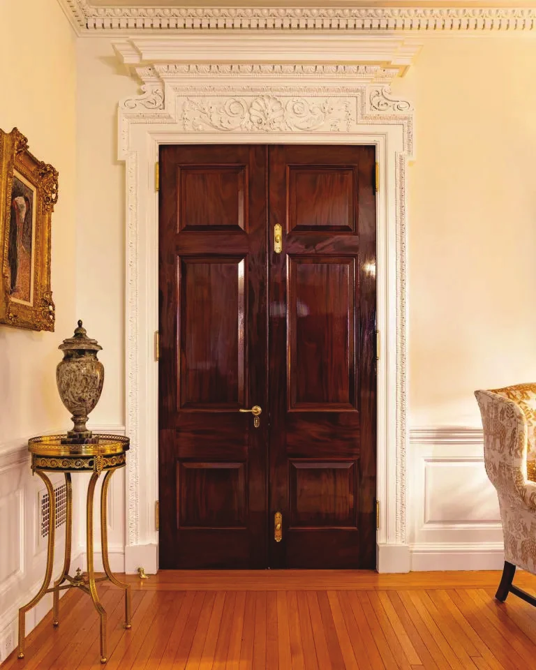 A lacquered double door in a classical room